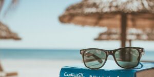 black framed Ray-Ban Wayfarer sunglasses on top of book