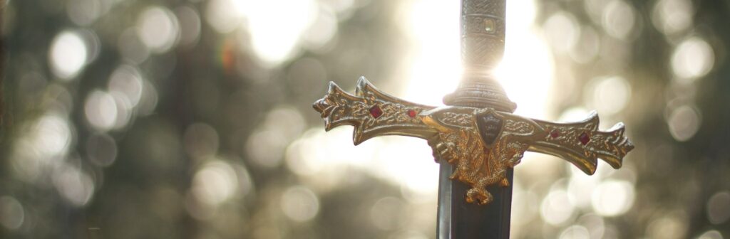 close-up photography of gold-colored and black sword