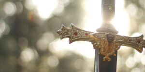 close-up photography of gold-colored and black sword