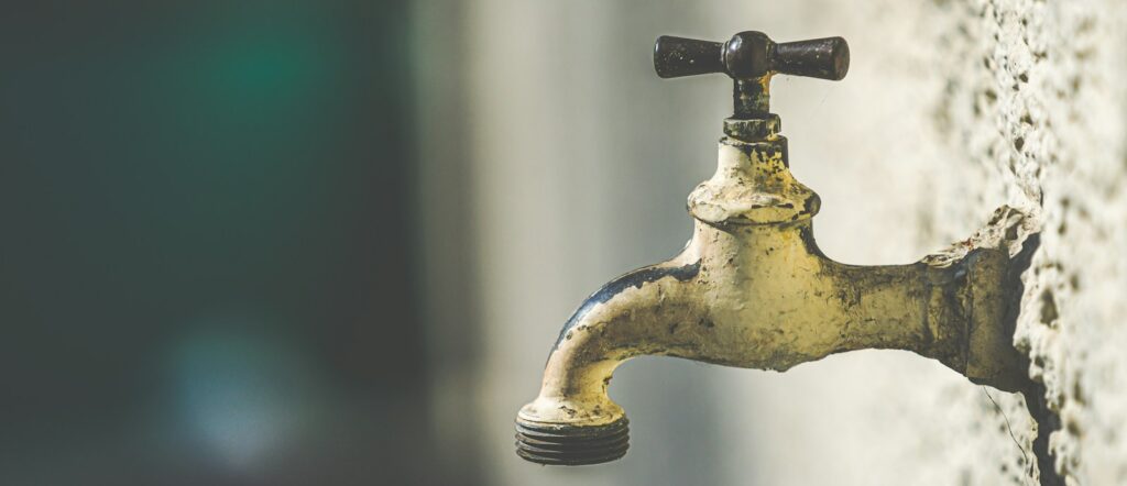 brass faucet with water droplets