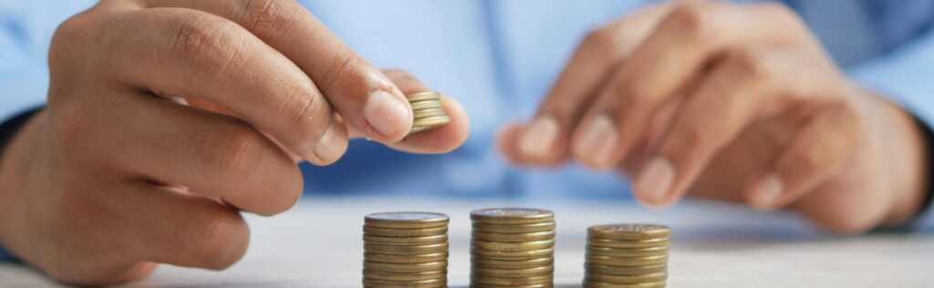 a person stacking coins on top of a table