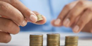 a person stacking coins on top of a table